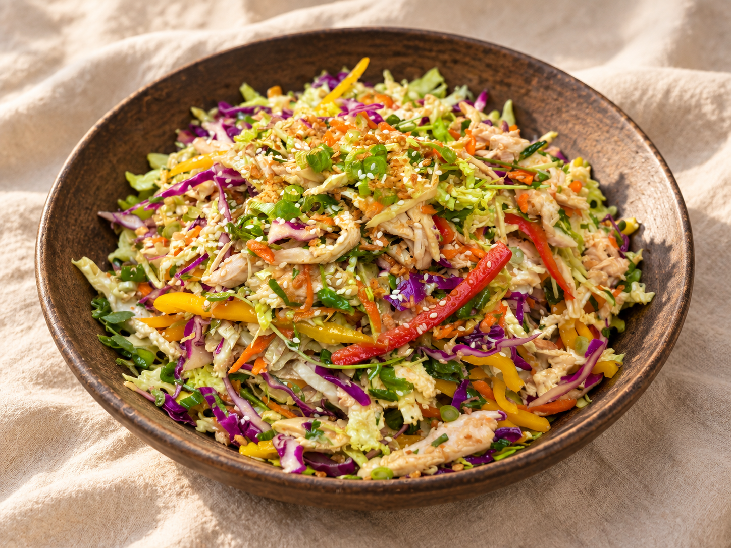 Headlights chicken cabbage salad with shredded chicken, cabbage, peppers, scallions, and sesame